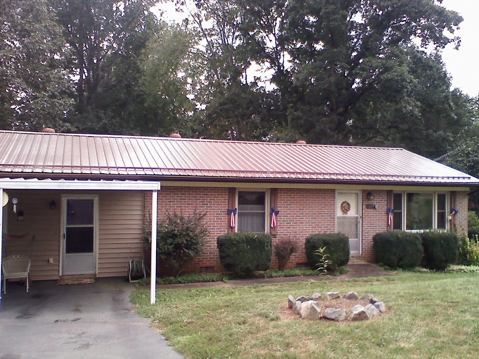 Bronze metal roof and carport on a brick ranch home — Roof Repair work by our crew in North Berwick